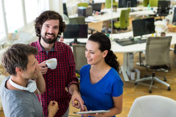 Group of graphics designers using digital tablet in office